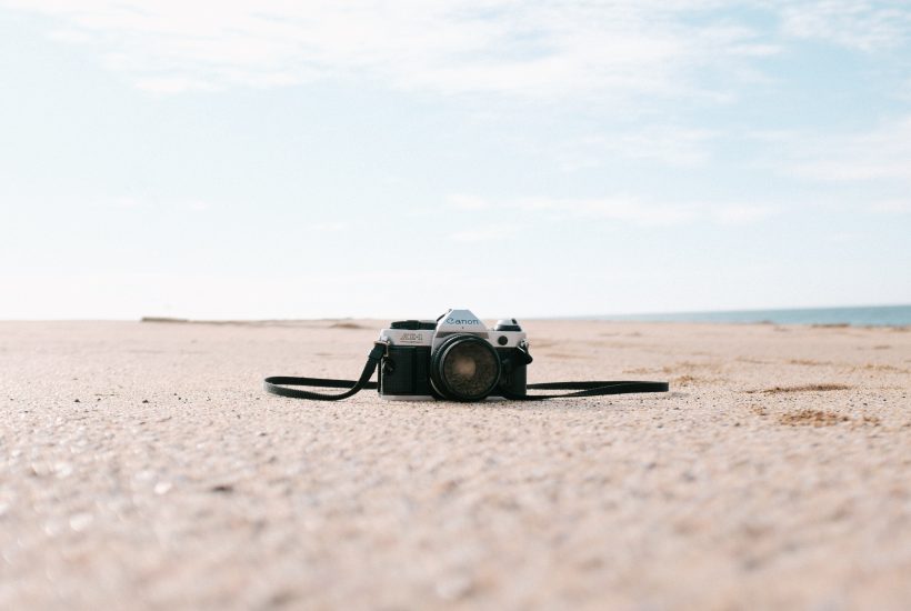 Camera on desert soil with sky in the background