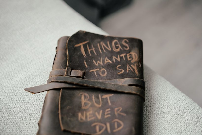 A leather diary that says "Things I wanted to say but never did" on the front