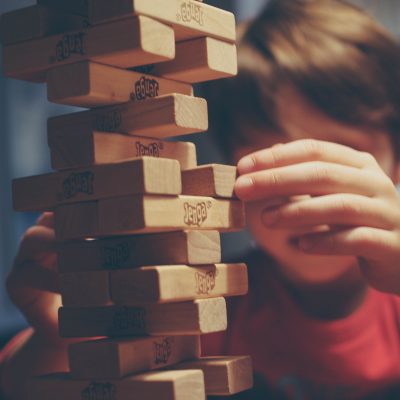 A kid playing jenga